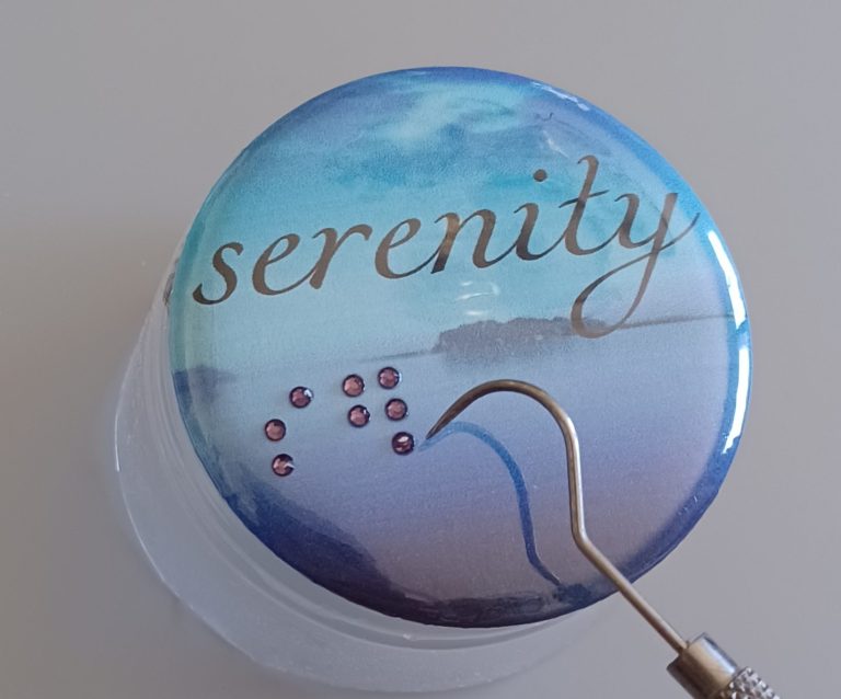 Braille 2.25 Round Button example 2.25 round pin back button, black print and raised braille dots reading serenity